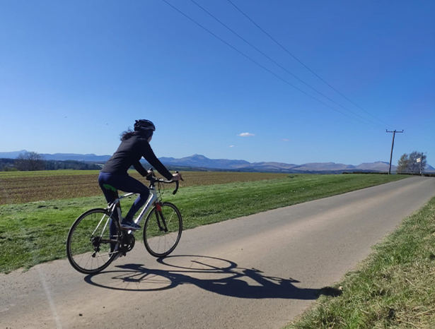 Student cycling on Bridge of Allan, Stirling