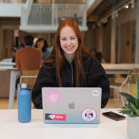 Apprentice using laptop in the workplace