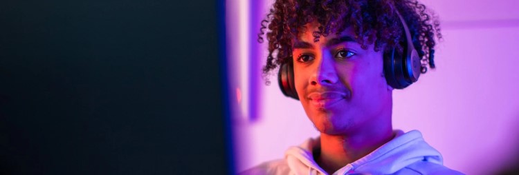 Young person using a PC with headphones