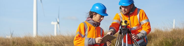 Female apprentice surveyor with a clipboard