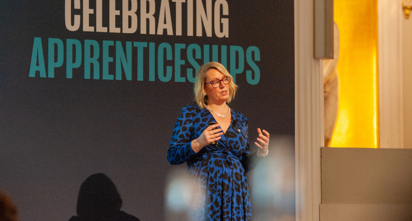Photograph of Lindsay Conroy presenting on-stage at Celebrating Apprenticeships event