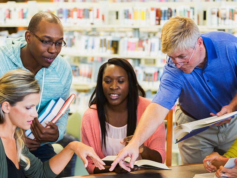 Diverse group of mature students with their tutor