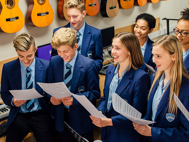 School pupils singing in a music lesson