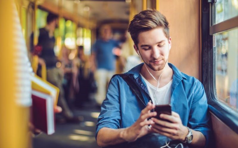 Student using mobile on bus