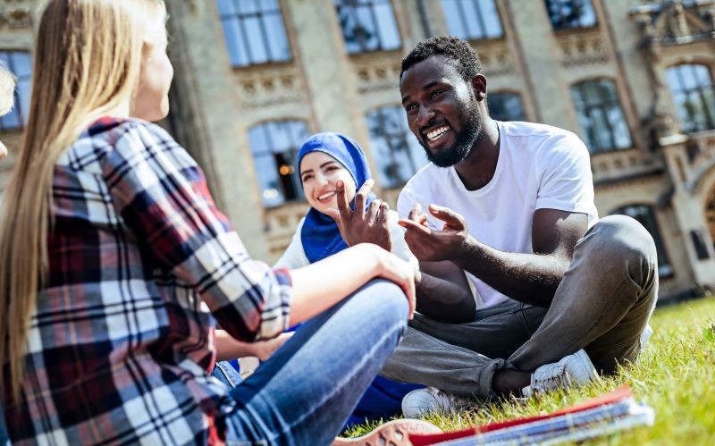 Students sitting on grass chatting