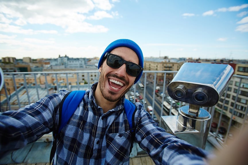 Student taking selfie on city viewing point 