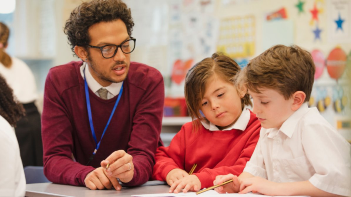 Photo of teacher and two pupils