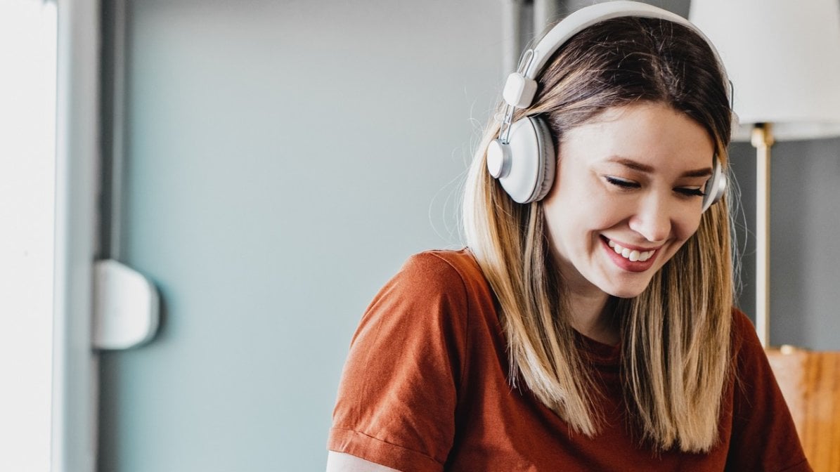 Young woman working with headphones on
