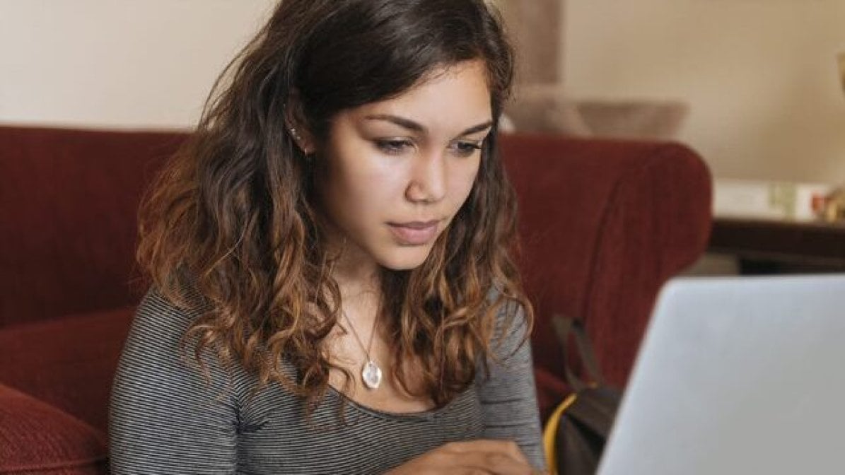 Student using laptop to reserarch uni support for bereaved children