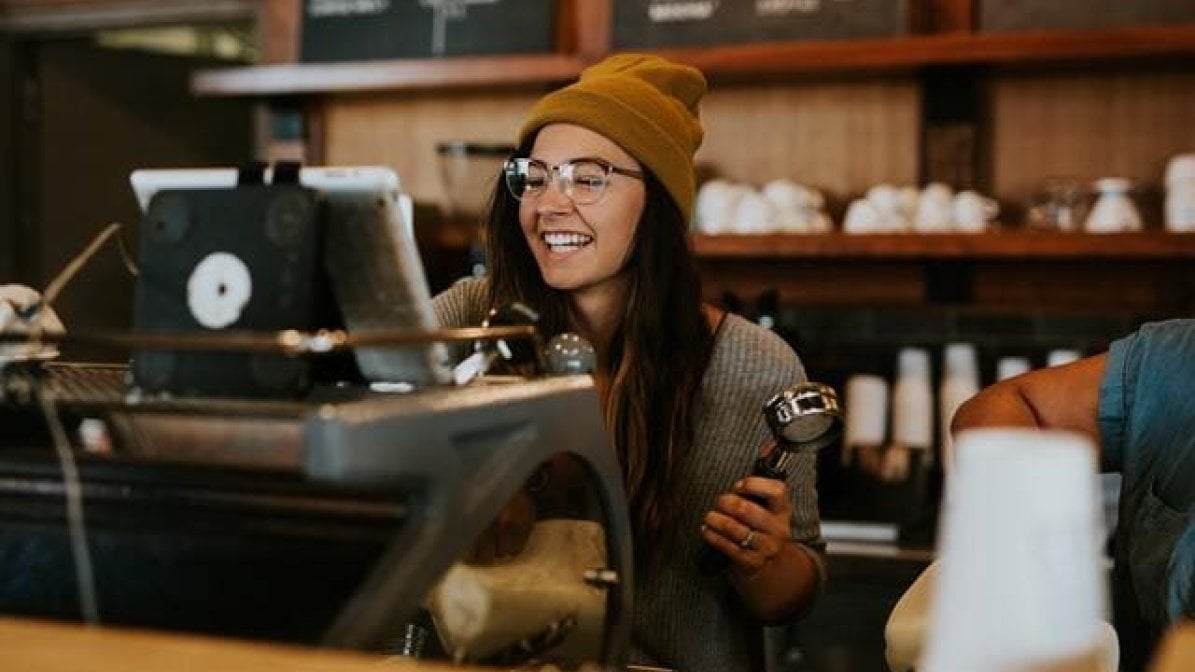 Catering and hospitality apprentice at work making coffee
