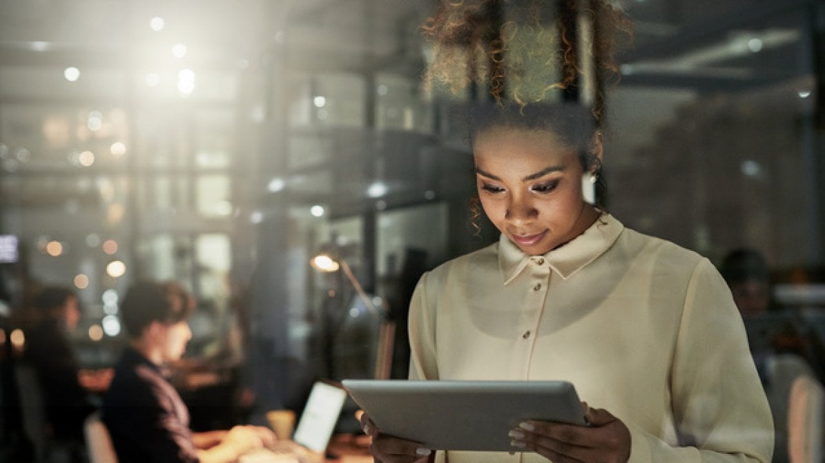 Digital community manager checking tablet in workplace
