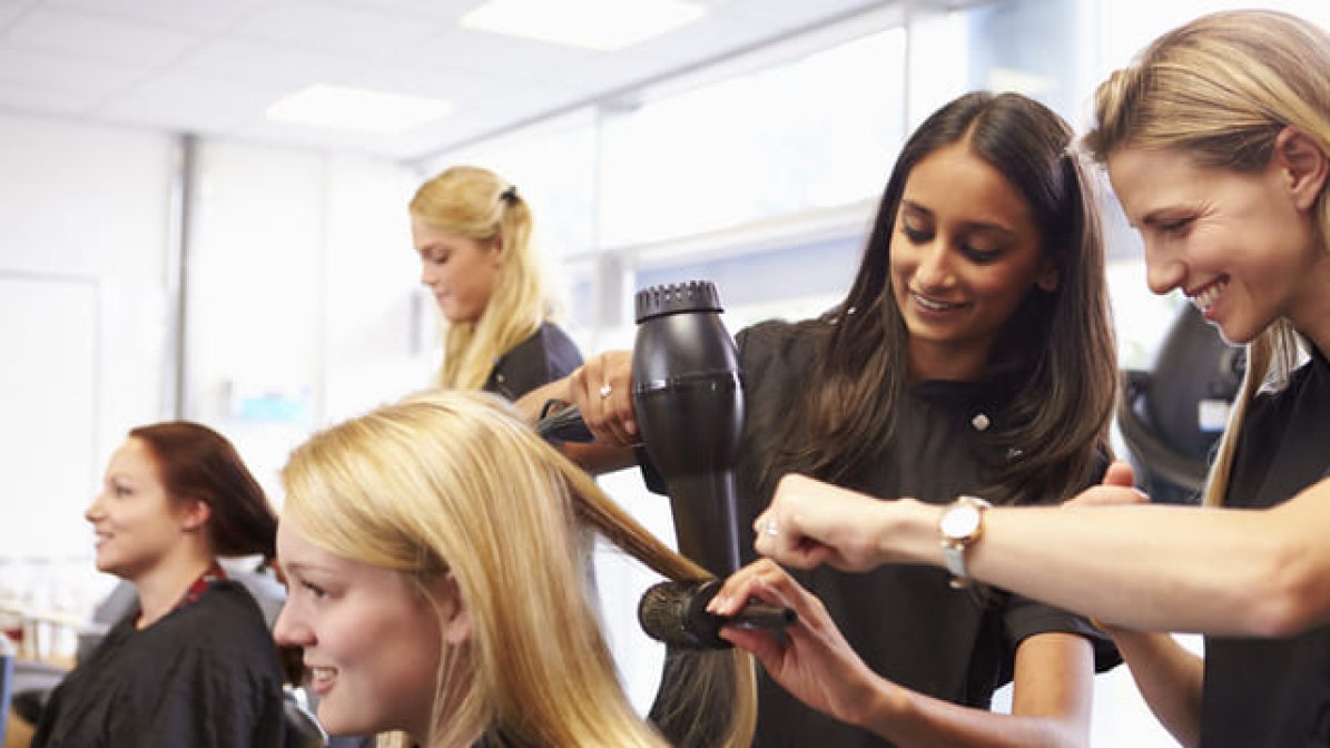 Hair and beauty apprentices cutting hair