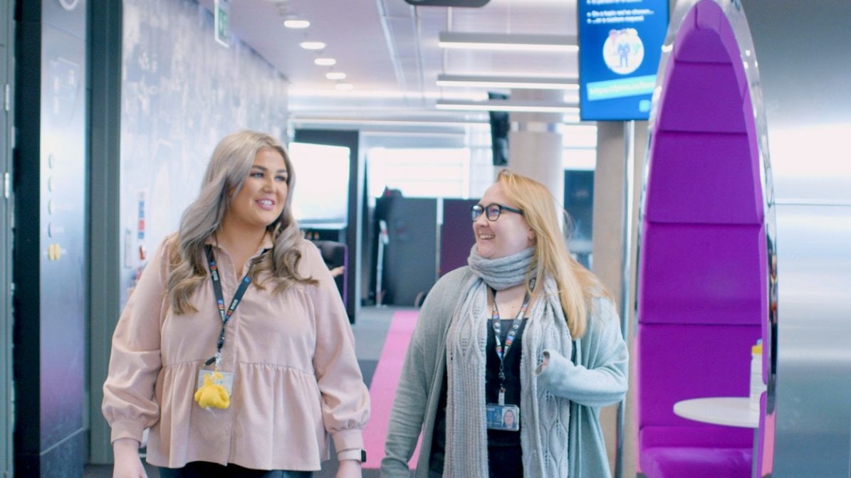 Vicki walking with her colleague in the BBC office