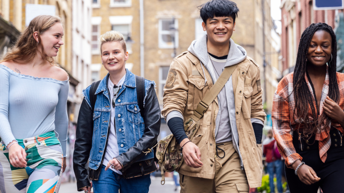A diverse group of young people walking down a high street