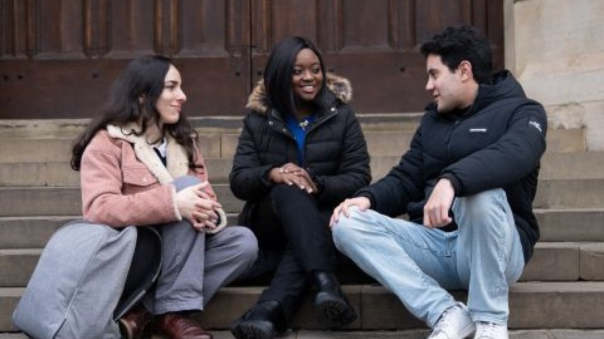 Students sitting on steps on uni campus