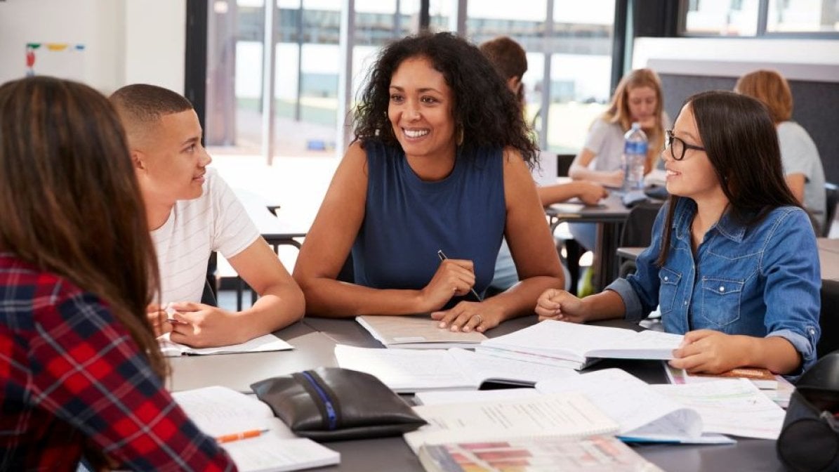 Adviser with students in classroom