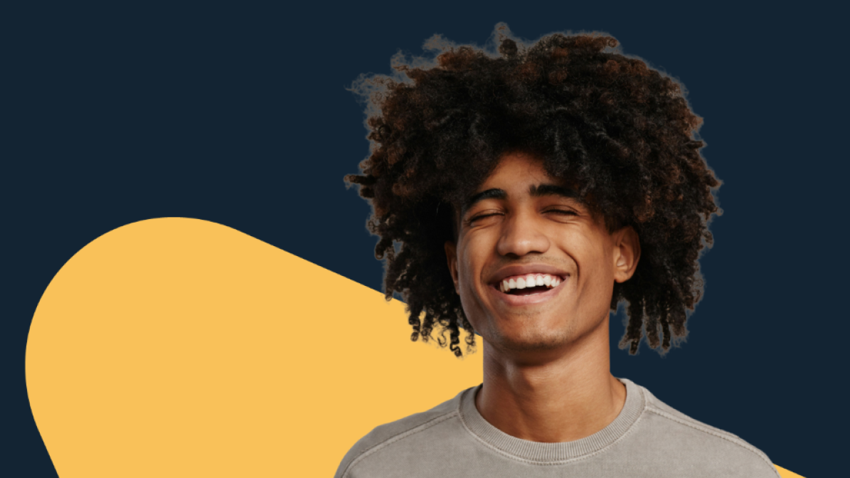 Person with a curly hair smiling with eyes closed against a dark blue background with a yellow shape