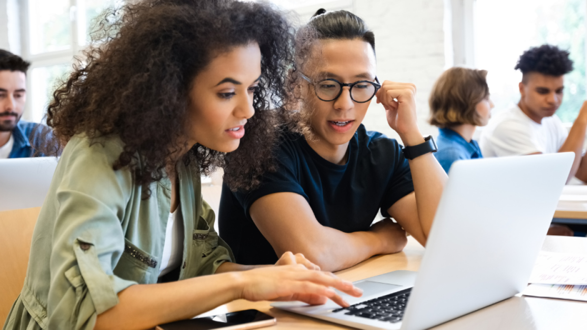 two students working together on laptop
