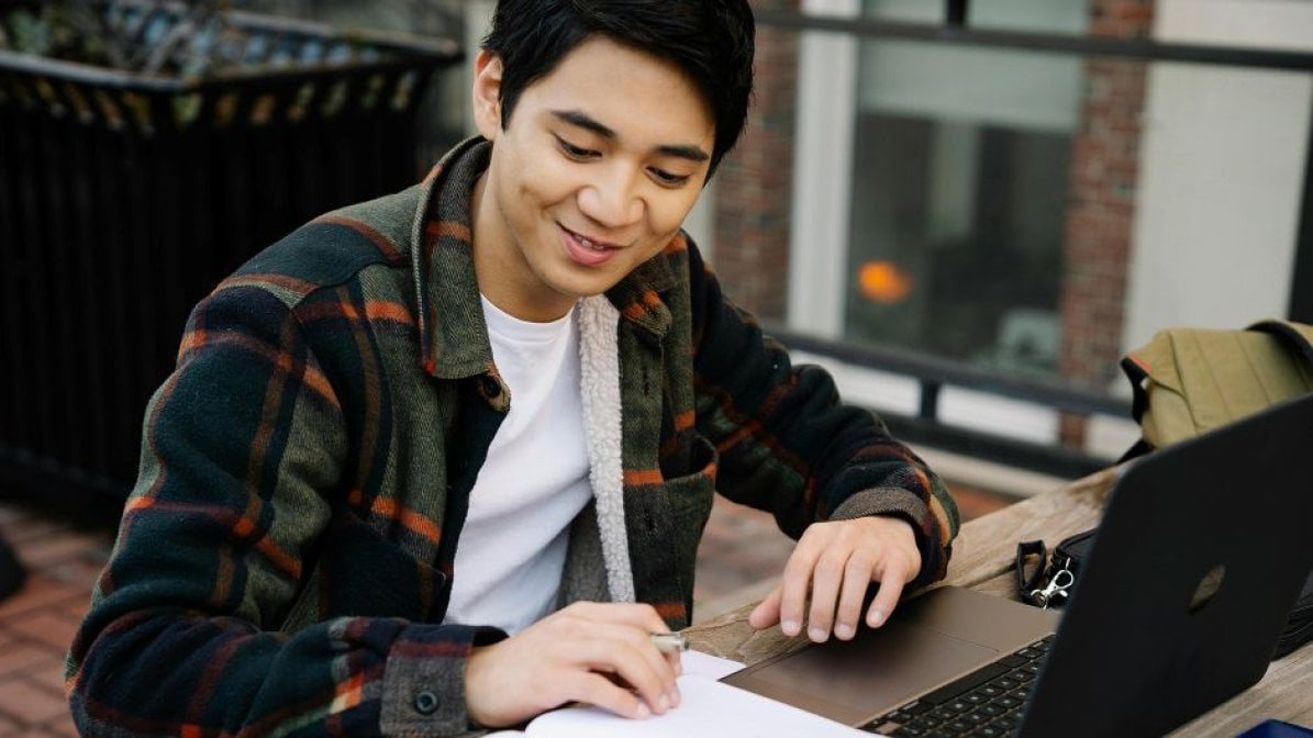 Student working on laptop at desk