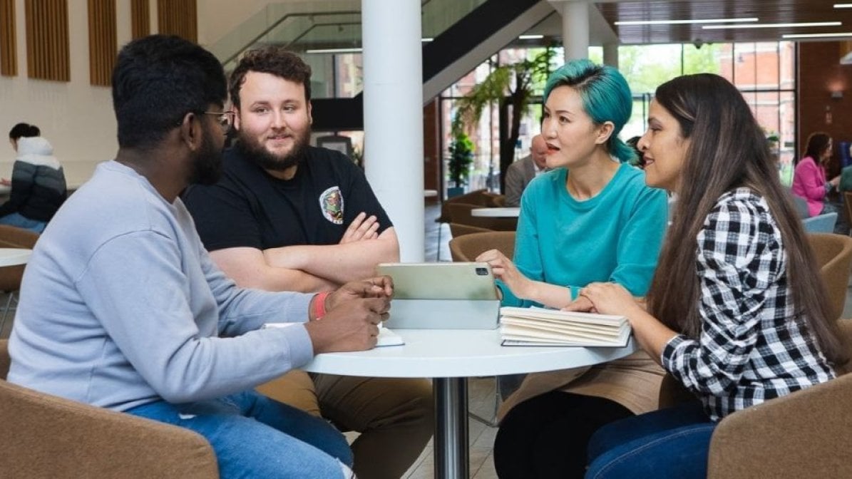 Students in a discussion sitting around a table