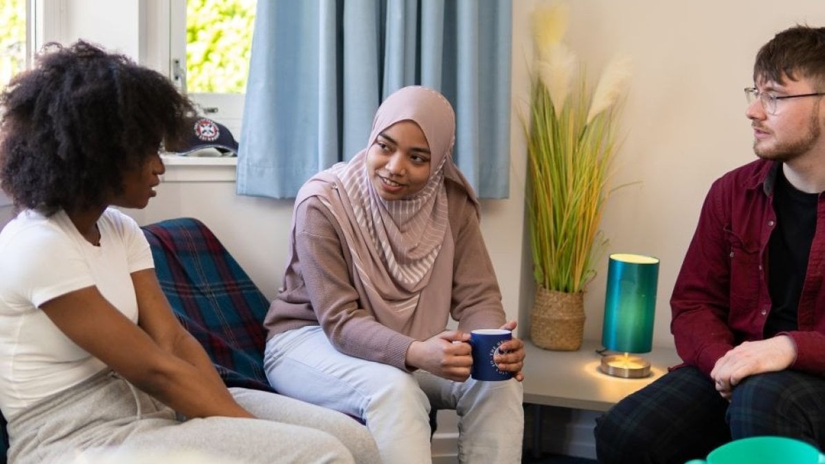 Students chatting in communal area in halls 