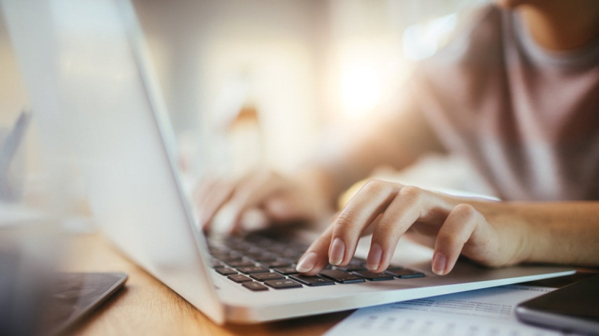 Close-up of person's hand using laptop 
