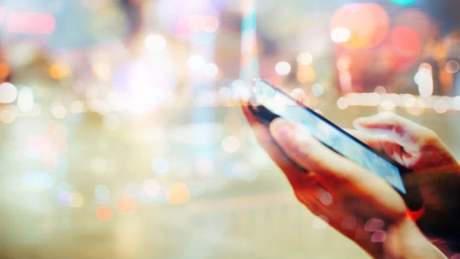 Person's hands holding a mobile