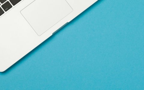 Photo of laptop on blue background