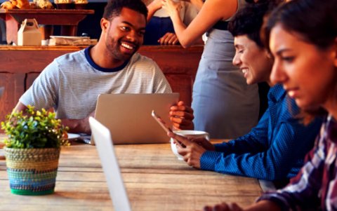 Photo of Postgraduate students interacting around a table