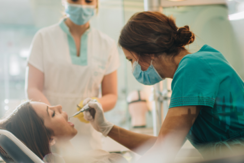 Dentist carrying out dental work on patient