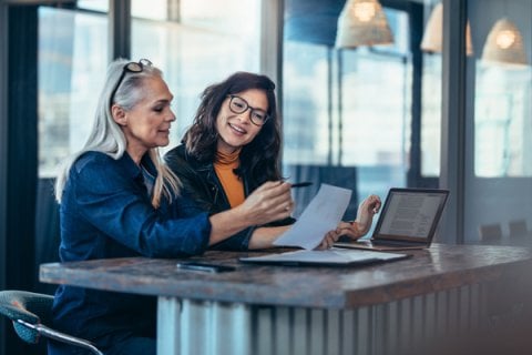Employer and apprentice chatting at work 
