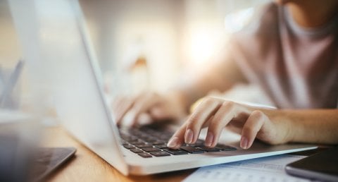 Close-up of person's hand using laptop