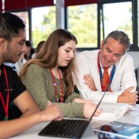 Adviser chatting with students