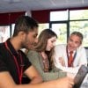 Adviser with two students sitting at a desk