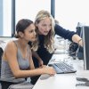 Adviser and student looking at PC