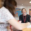 Student and adviser chatting in classroom 