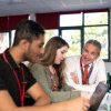Adviser with students looking at UCAS Hub on laptop