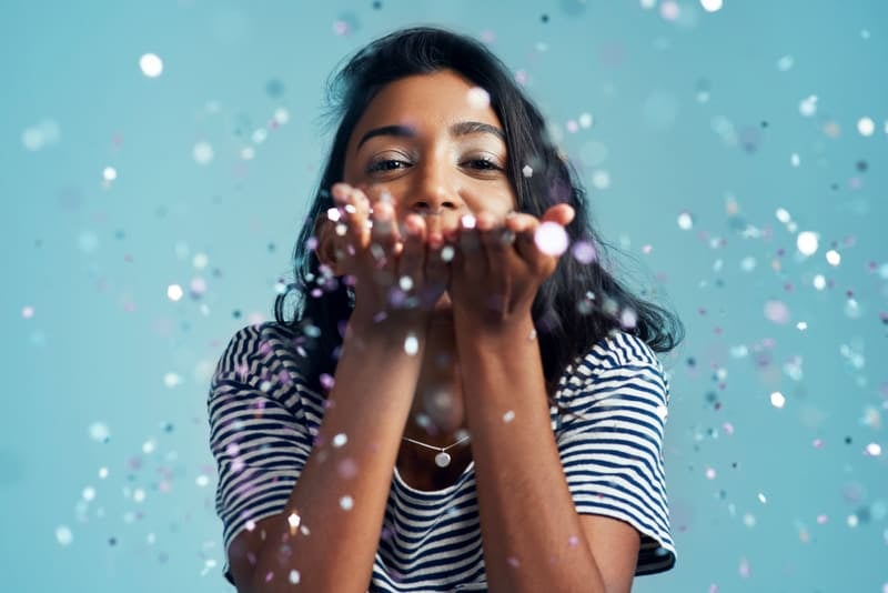 Girl blowing glitter