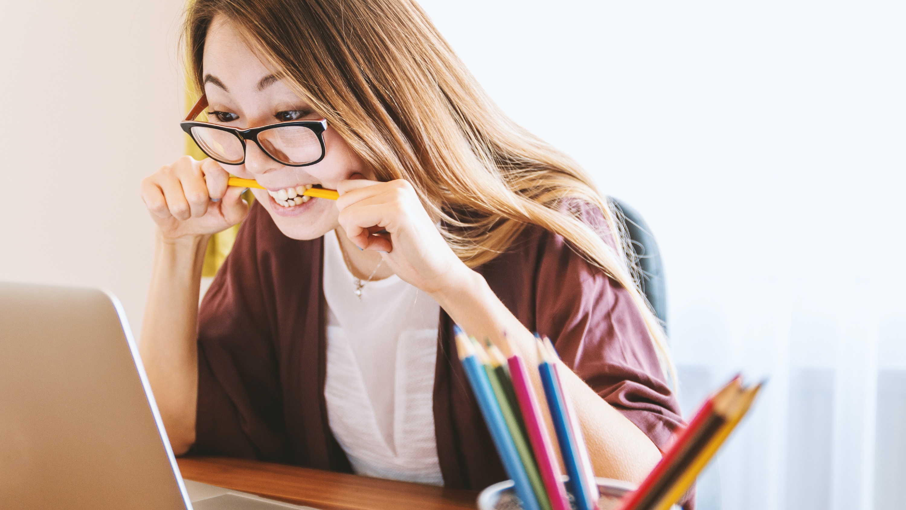 A woman biting a pencil